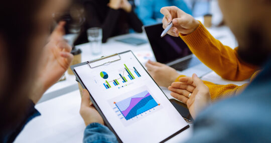 Team reviewing customer insights and market research data displayed in charts